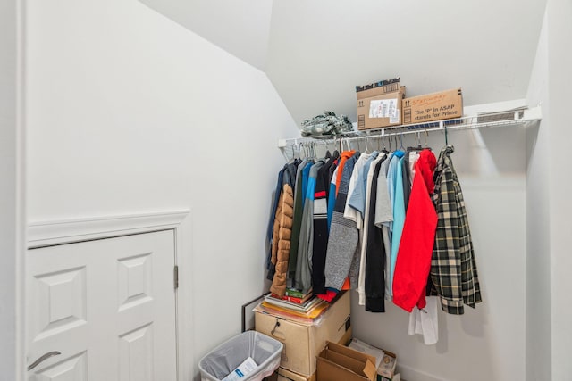 walk in closet with vaulted ceiling