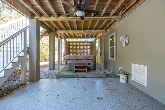 view of patio with stairway and a hot tub