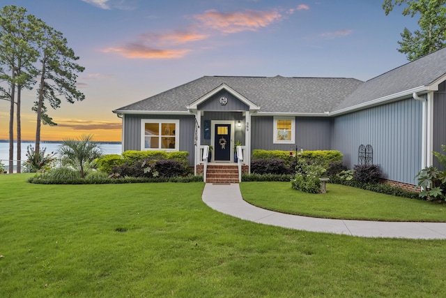 359 Green St, Santee, SC 29142 - view of front of house featuring a front yard, roof with shingles, and a water view