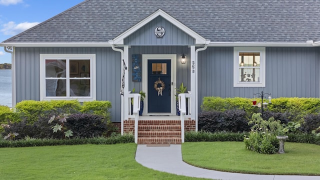 359 Green St, Santee, SC 29142 - doorway to property with a yard and roof with shingles