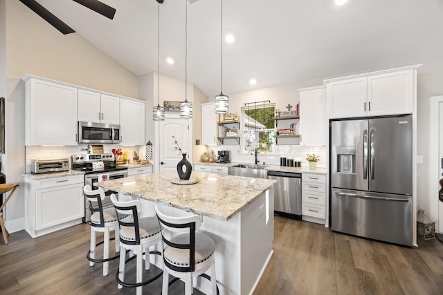 359 Green St, Santee, SC 29142 - kitchen featuring appliances with stainless steel finishes, a kitchen island, backsplash, white cabinets, and high vaulted ceiling