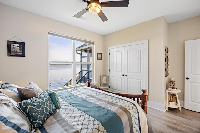 359 Green St, Santee, SC 29142 - bedroom featuring wood finished floors, a water view, a closet, and a ceiling fan
