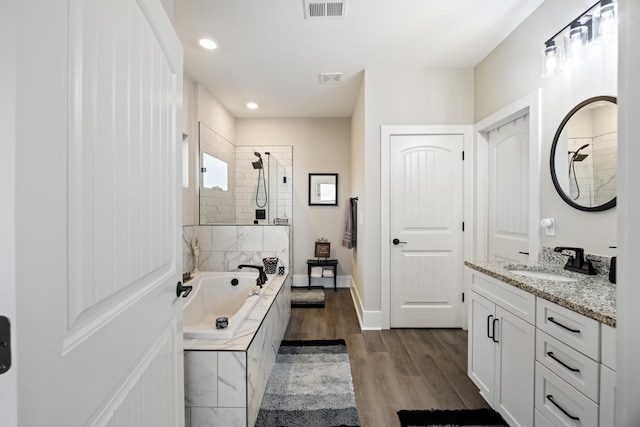359 Green St, Santee, SC 29142 - full bathroom with vanity, a garden tub, tiled shower, wood finished floors, and recessed lighting
