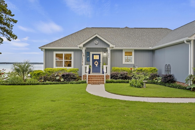 359 Green St, Santee, SC 29142 - view of front facade with a front yard, a water view, and roof with shingles