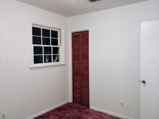 unfurnished bedroom featuring a closet and carpet