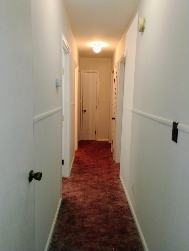 hallway with dark carpet