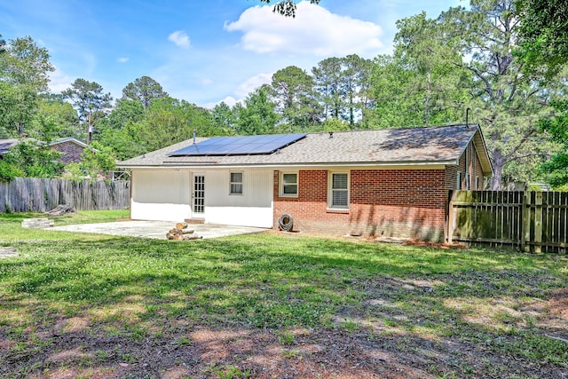403 Forest Cir, Summerville, SC 29483 - rear view of property with brick siding, a fenced backyard, solar panels, a patio area, and a lawn