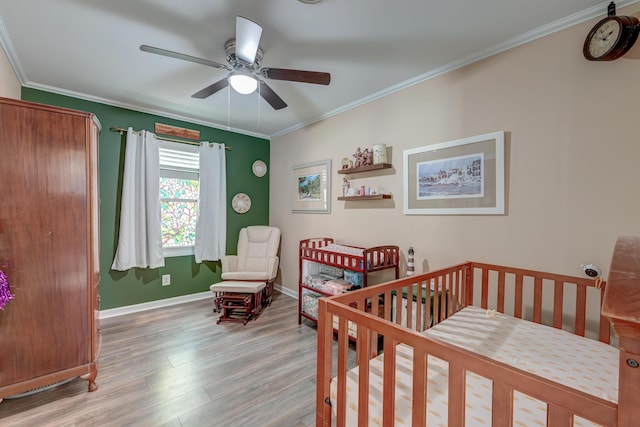 403 Forest Cir, Summerville, SC 29483 - bedroom featuring ornamental molding, wood finished floors, baseboards, ceiling fan, and a crib