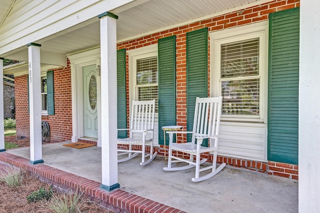 403 Forest Cir, Summerville, SC 29483 - doorway to property featuring covered porch and brick siding