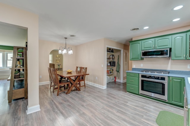403 Forest Cir, Summerville, SC 29483 - kitchen featuring appliances with stainless steel finishes, green cabinetry, light wood finished floors, and arched walkways