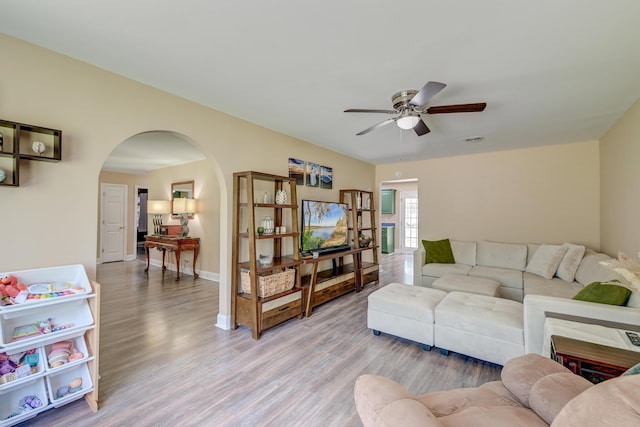 403 Forest Cir, Summerville, SC 29483 - living room with baseboards, arched walkways, light wood-style flooring, and ceiling fan