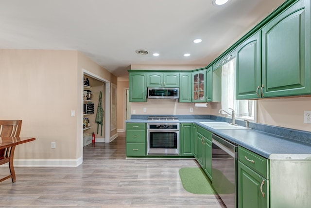 403 Forest Cir, Summerville, SC 29483 - kitchen featuring recessed lighting, a sink, light wood-style flooring, green cabinets, and stainless steel appliances