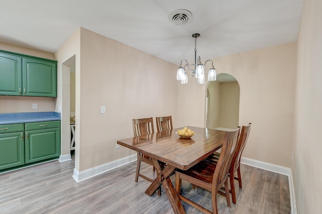 403 Forest Cir, Summerville, SC 29483 - dining room featuring visible vents, arched walkways, light wood finished floors, and baseboards