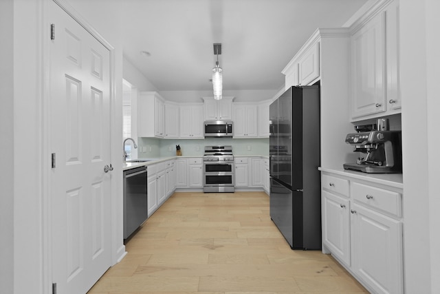 132 Fresh Meadow Ln, Mount Pleasant, SC 29466 - kitchen featuring appliances with stainless steel finishes, light wood-type flooring, light countertops, and white cabinetry