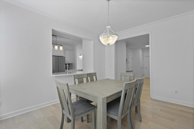 132 Fresh Meadow Ln, Mount Pleasant, SC 29466 - dining space featuring crown molding, light wood-type flooring, and a chandelier