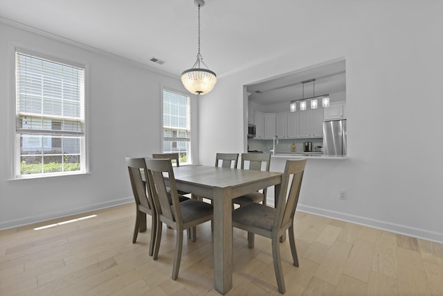 132 Fresh Meadow Ln, Mount Pleasant, SC 29466 - dining space with healthy amount of natural light, crown molding, and light wood finished floors