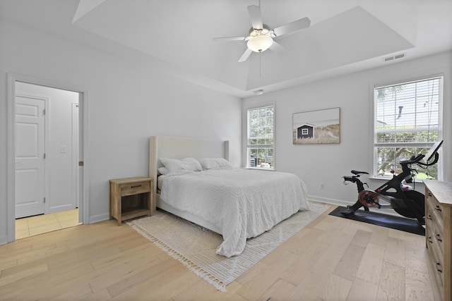 132 Fresh Meadow Ln, Mount Pleasant, SC 29466 - bedroom with light wood-style floors, ceiling fan, and a tray ceiling