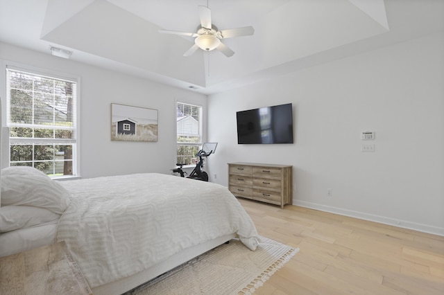 132 Fresh Meadow Ln, Mount Pleasant, SC 29466 - bedroom featuring a raised ceiling, light wood-style flooring, and a ceiling fan