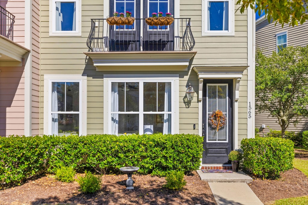 view of exterior entry featuring a balcony