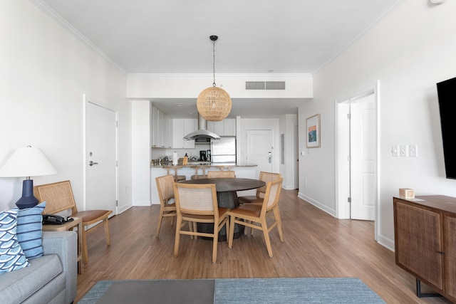 5802 Palmetto Dr Unit B-521/519, Isle Of Palms, SC 29451 - dining space featuring wood finished floors, crown molding, and baseboards