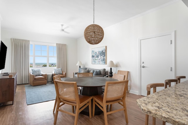 5802 Palmetto Dr Unit B-521/519, Isle Of Palms, SC 29451 - dining space with wood finished floors, ornamental molding, and a ceiling fan