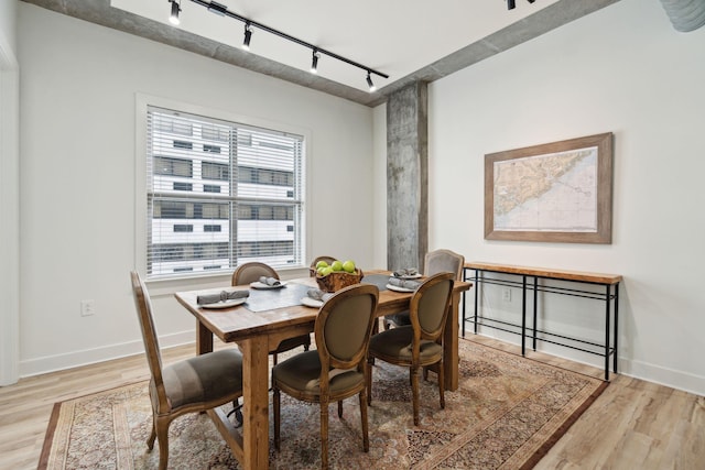 dining space featuring track lighting and light hardwood / wood-style floors