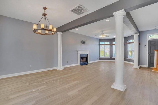 unfurnished living room featuring beam ceiling, light hardwood / wood-style flooring, ceiling fan with notable chandelier, and plenty of natural light