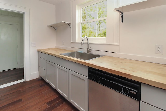 kitchen with butcher block countertops, dark hardwood / wood-style flooring, sink, and stainless steel dishwasher