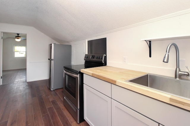 kitchen featuring wooden counters, white cabinets, sink, appliances with stainless steel finishes, and dark hardwood / wood-style flooring