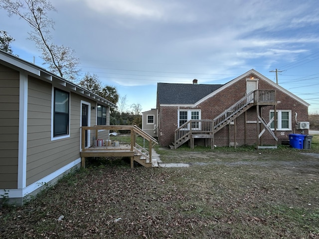 back of property featuring a wooden deck