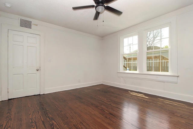 empty room featuring ceiling fan, dark hardwood / wood-style flooring, and a textured ceiling