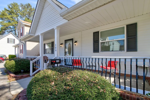 view of exterior entry with a porch