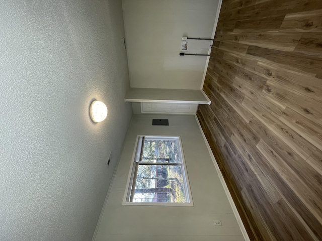 spare room featuring wooden walls