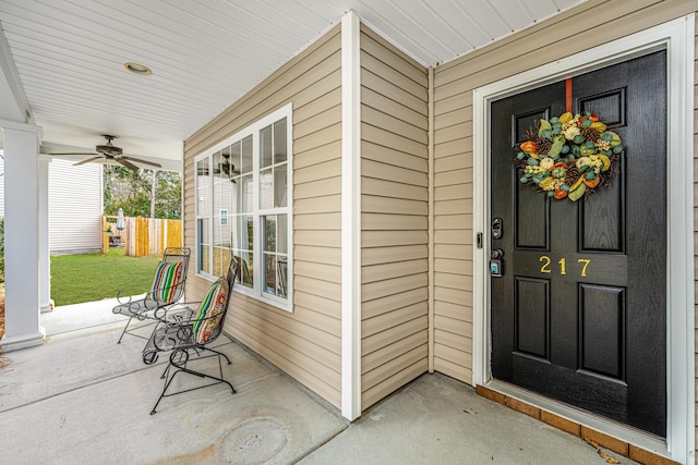 entrance to property featuring covered porch and ceiling fan