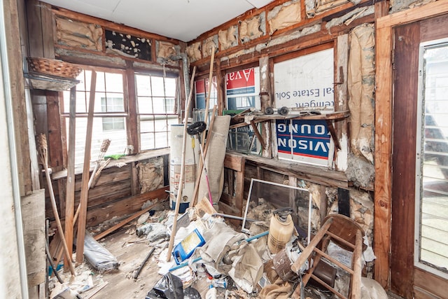 miscellaneous room with a healthy amount of sunlight and water heater