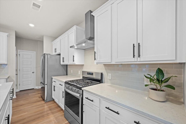 217 Lucca Dr, Summerville, SC 29486 - kitchen with light stone counters, visible vents, white cabinetry, appliances with stainless steel finishes, and wall chimney exhaust hood