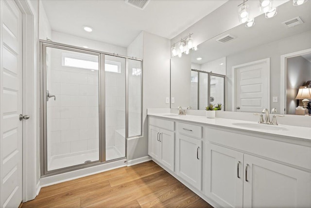 217 Lucca Dr, Summerville, SC 29486 - bathroom with a stall shower, visible vents, a sink, and wood finished floors