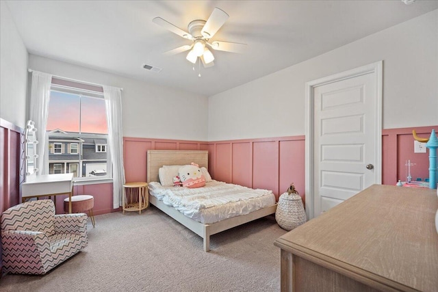 217 Lucca Dr, Summerville, SC 29486 - bedroom featuring ceiling fan, wainscoting, visible vents, and light colored carpet