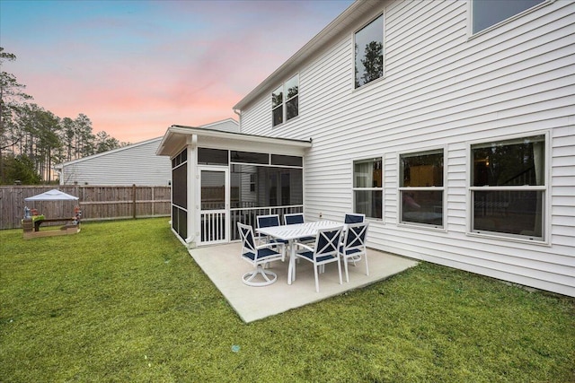 217 Lucca Dr, Summerville, SC 29486 - back of property at dusk featuring a yard, a patio area, fence, and a sunroom