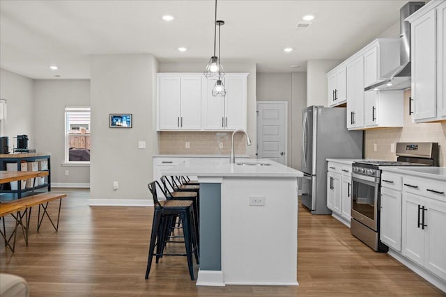 217 Lucca Dr, Summerville, SC 29486 - kitchen featuring stainless steel appliances, a sink, light countertops, an island with sink, and pendant lighting