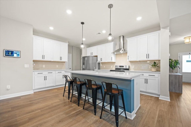 217 Lucca Dr, Summerville, SC 29486 - kitchen featuring stainless steel appliances, white cabinets, and wall chimney exhaust hood