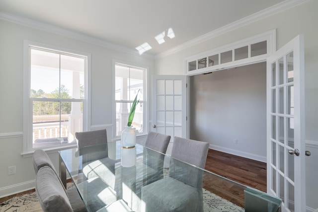 dining room with hardwood / wood-style floors, crown molding, and french doors