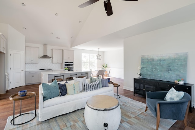 living room with high vaulted ceiling, light hardwood / wood-style floors, and ceiling fan