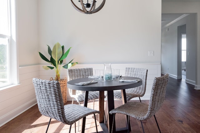 dining space featuring hardwood / wood-style floors and ornamental molding