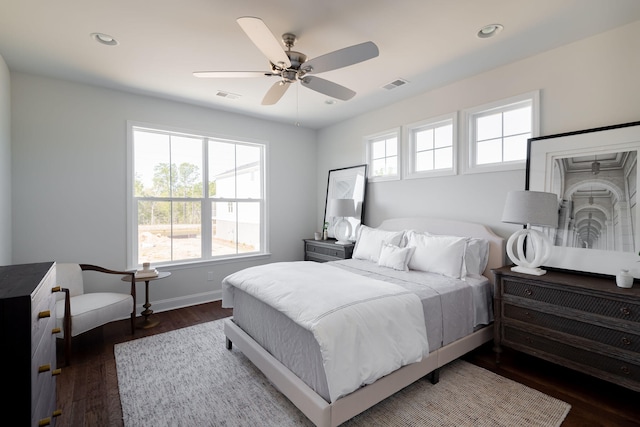 bedroom with dark hardwood / wood-style flooring and ceiling fan