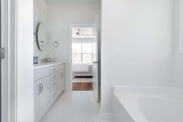 bathroom with vanity, tile floors, and a bath to relax in