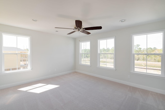 carpeted empty room featuring ceiling fan