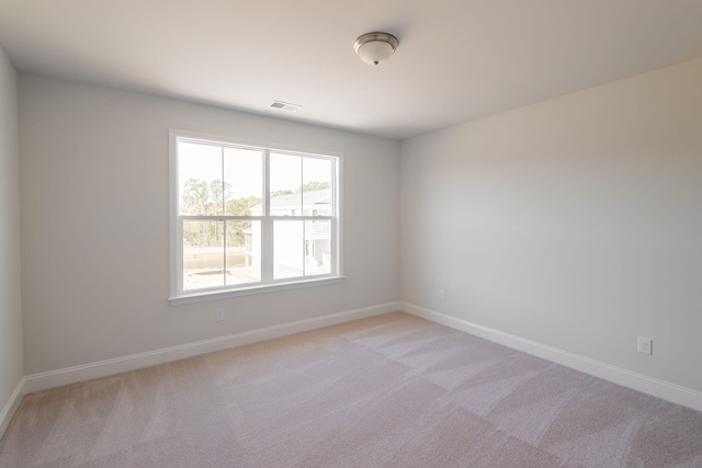 spare room with light carpet