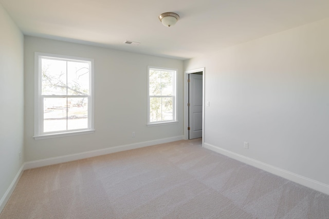 empty room featuring light colored carpet