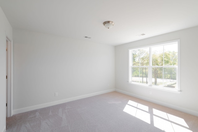 empty room featuring light colored carpet